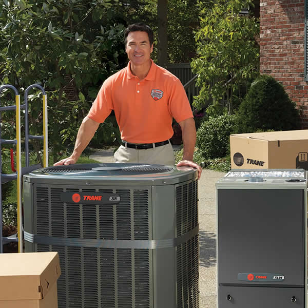 Trane Dealer With Products Around Him